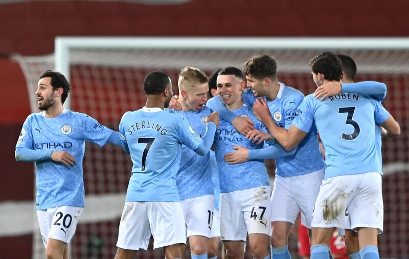 Manchester City's Phil Foden, centre, celebrates scoring their side's fourth goal. PA