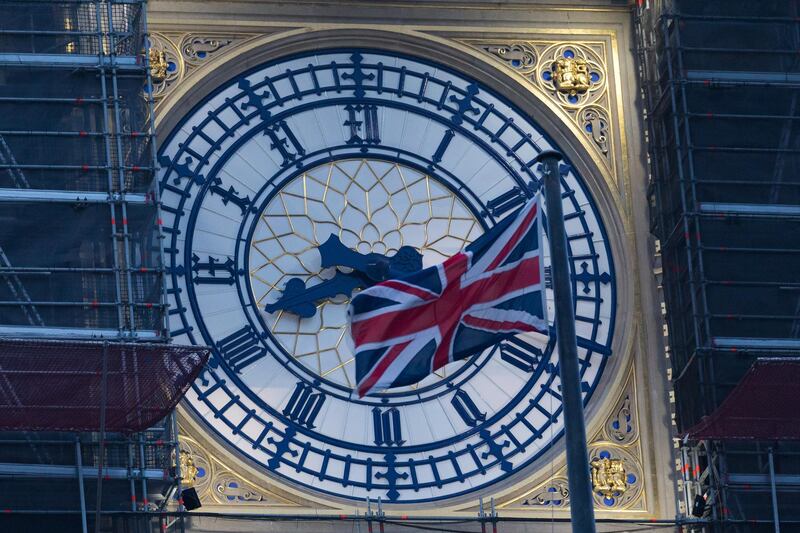 The Big Ben clock face with a Union Jack flag seen at dawn in Westminster, London. Britain left the European Union at 11pm on 31 December 2020. EPA