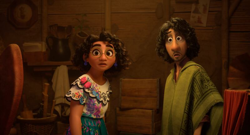 Mirabel, voiced by Stephanie Beatriz, and Bruno, voiced by John Leguizamo, in a scene from the animated film 'Encanto'. AP