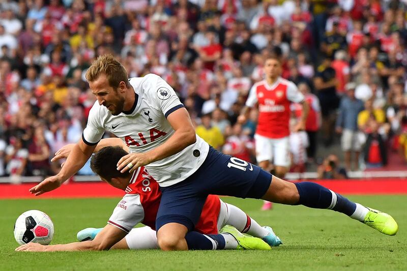 Arsenal's Sokratis Papastathopoulos fouls Tottenham Hotspur's Harry Kane. AFP