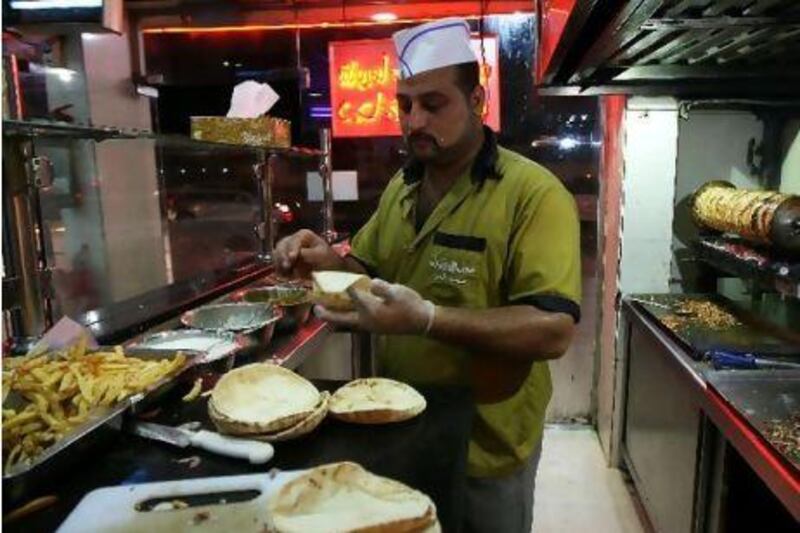 Mohammed Saeed Abdul from Egypt makes chicken shawarma at the Foul wa Felafel restaurant in Sharjah.