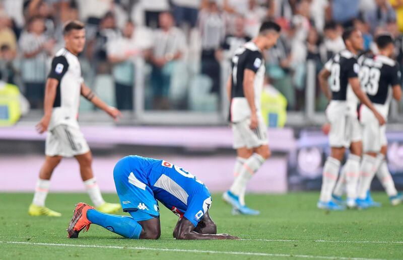 Kalidou Koulibaly sinks to the pitch after his injury time own goal. AP Photo