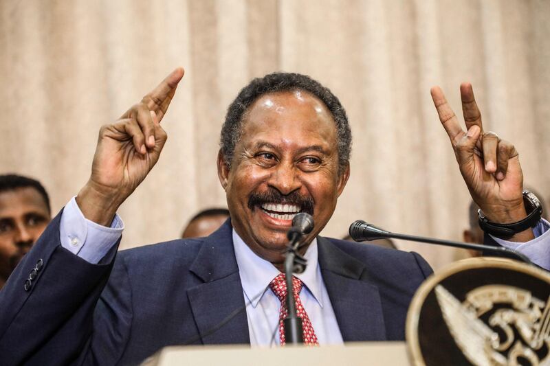 FILE - In this Wednesday, Aug. 21, 2019 file photo, Sudan's Prime Minister Abdalla Hamdok speaks during a news conference in Khartoum, Sudan. President Donald Trump on Monday, Oct. 19, 2020 said Sudan will be removed from the U.S. list of state sponsors of terrorism if it follows through on its pledge to pay $335 million to American terror victims and families. Sudan is on a fragile path to democracy after a popular uprising last year led the military to overthrow autocratic leader Omar al-Bashir in April 2019. A military-civilian government now rules the country, with elections possible in late 2022. (AP Photo, File)