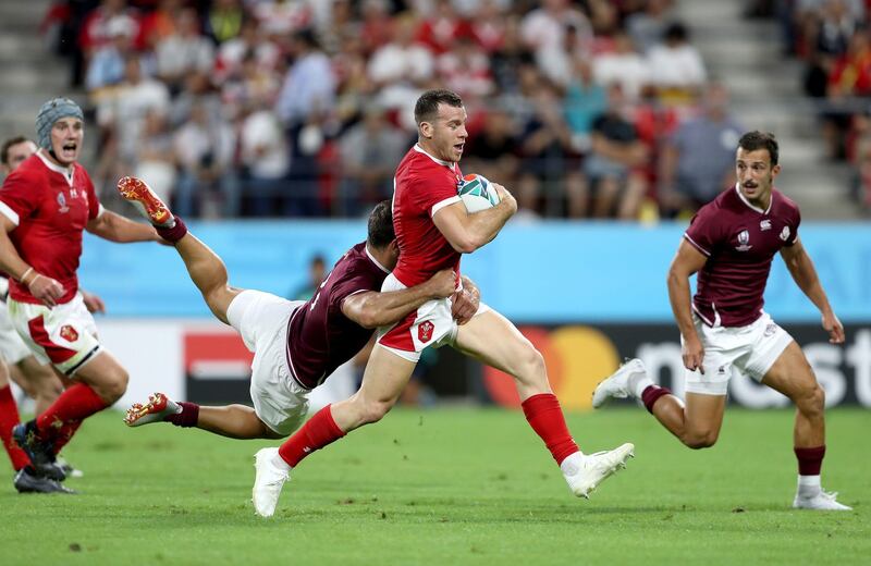 Wales' Gareth Davies is tackled by Georgia's Davit Kacharava during the 2019 Rugby World Cup Pool D match at City of Toyota Stadium, Japan. PA