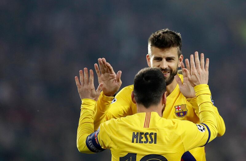 Barcelona's Lionel Messi celebrates a his goal with Gerard Pique. AP