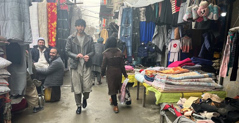 People browse second-hand market stalls in central Kabul. Photo: Ali M Latifi