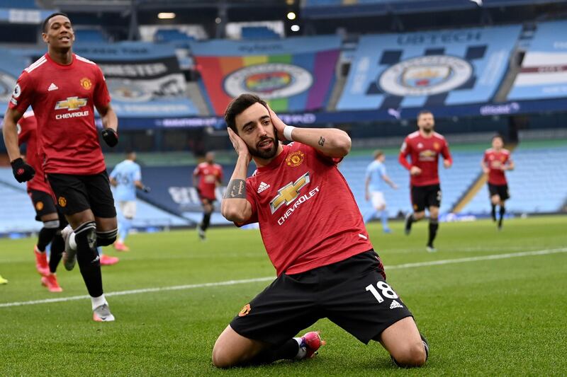 Manchester United's Bruno Fernandes celebrates after scoring the opening goal during the English Premier League soccer match between Manchester City and Manchester United at the Etihad Stadium in Manchester, England, Sunday, March 7, 2021. (Laurence Griffiths/Pool via AP)
