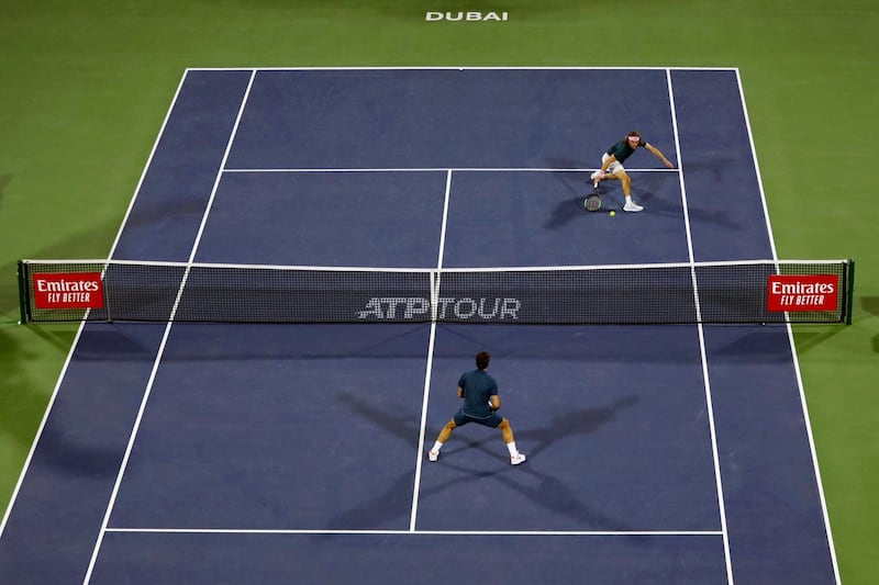 Tsitsipas returns the ball to Federer during the match on Centre Court at the Dubai Duty Free Tennis Stadium. AFP
