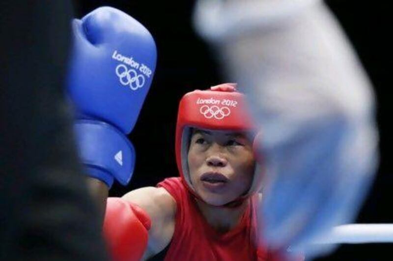 Mary Kom, the Indian boxer, during her semi-final defeat to Great Britain's Nicola Adams. Kom, who has won multiple world championship titles, was not considered a star in her country before the Olympics. Jack Guez / AFP