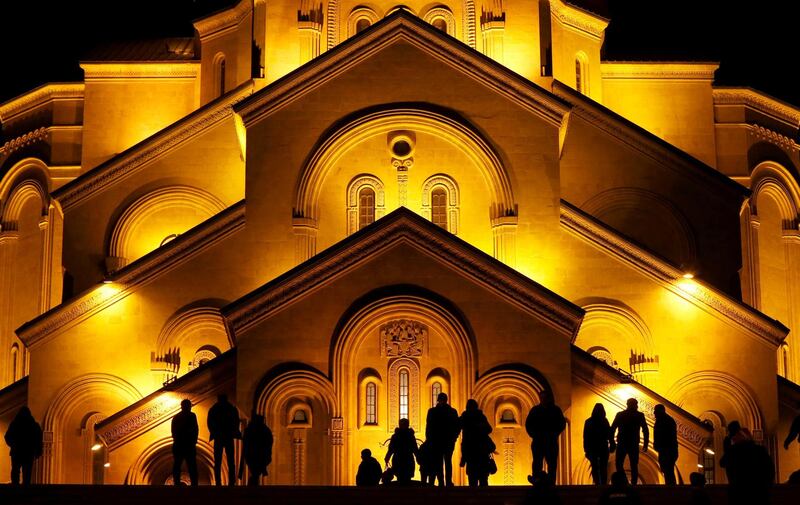 People walk in front of the Holy Trinity cathedral a midnight Christmas service in Tbilisi, Georgia. David Mdzinarishvili / Reuters