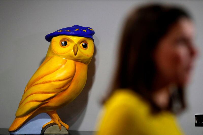 A sculpture of an owl is bedecked with an EU beret as Liberal Democrat leader Jo Swinson gestures during an interview at a general election campaign event in Bath, UK.  AFP
