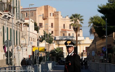 A Carabinieri (Italian paramilitary) officer patrols the area next to Villa Igiea, the site of an international conference on Libya, in Palermo, Italy, Monday, Nov. 12, 2018. A gathering of leaders of Libya's quarrelling factions and of countries keen on stabilizing the North African nation is taking place Sicily. It aims to find a political settlement that would bolster the fight against Islamic militants and stop illegal migrants crossing the Mediterranean to Europe's southern shores. (AP Photo/Antonio Calanni)