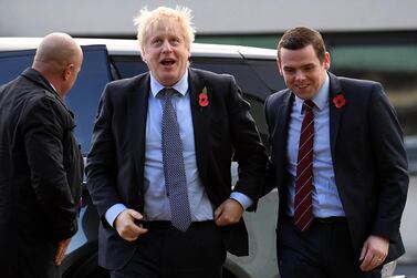  Britain's Prime Minister Boris Johnson (C) is greeted by Conservative party candidate for Moray, Douglas Ross (R) as he arrives for a general election campaign visit to Diageo's Roseisle Distillery near Elgin, north east Scotland AFP