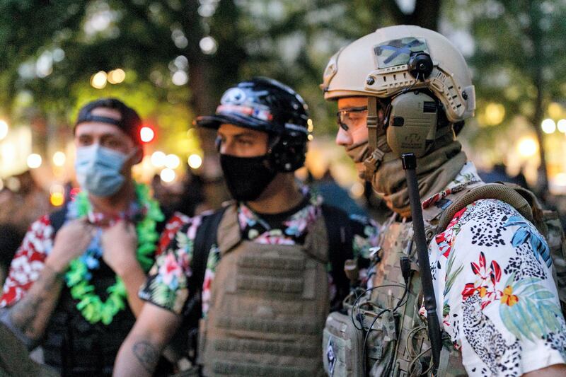 PORTLAND, OREGON, USA - JULY 24: The 'Boogaloo Bois', an armed libertarian group, dress in their signature Hawaiian shirts during a protest on 24, 2020 in Portland, United States. Thousands of people, including mothers, lawyers, health-care workers, and veterans demonstrated in Portland, Oregon on July 24, 2020 for racial justice, and against Donald TrumpÃ¢s insertion of Federal officers into Portland, Oregon. (Photo by John Rudoff/Anadolu Agency via Getty Images)