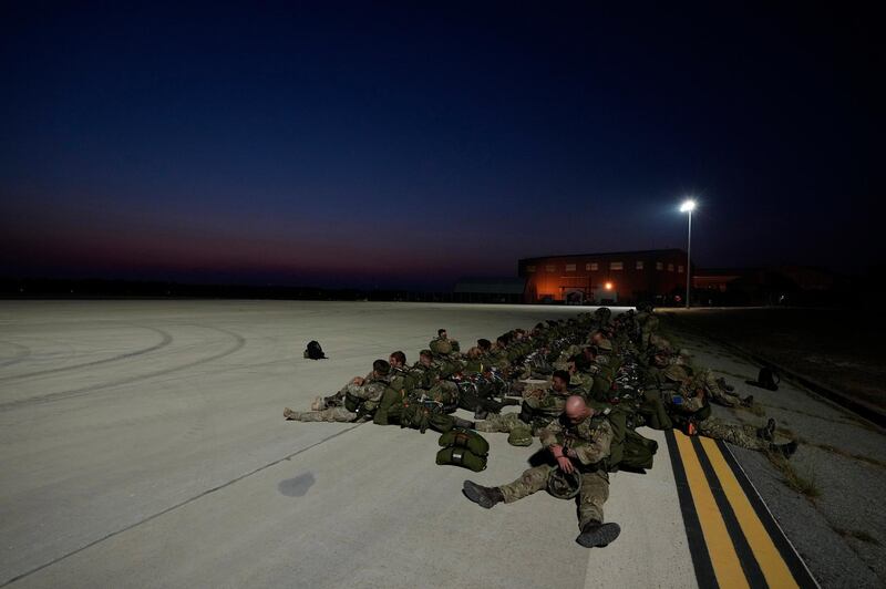 British paratroopers with the 16th Air Assault Brigade sit on the apron at RAF Akrotiri air base in Cyprus waiting to board a C130 transport aircraft for an airdrop over Jordan as part of a joint exercise with Jordanian soldiers. AP