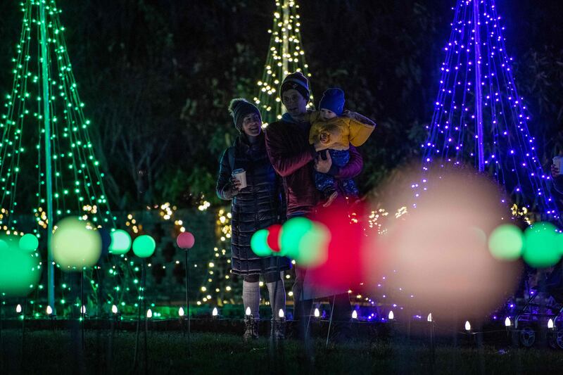 Families walk the lighted paths around the grounds at the Eleanor Cabot Bradley Estate. AFP