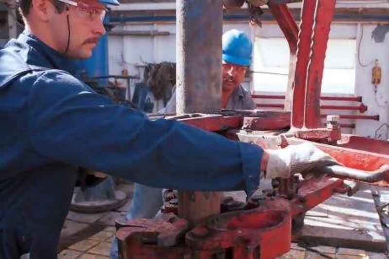 An Apache Corp. work crew drills for oil thirty miles off the Louisiana coast in the Gulf of Mexico in this June 23, 1999 photo. From left are Shannon Beasley,  Johnny Graham and  Silas Green. ConocoPhillips, Apache Corp. and other energy producers may benefit from a proposal by U.S. lawmakers to offer $7.4 billion in tax breaks and other incentives to help develop domestic supplies of oil and gas. Photographer: Donny McCallum. Bloomberg News.