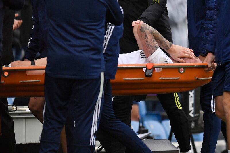 Leeds United midfielder Stuart Dallas is taken off on a stretcher after a collision with Jack Grealish. AFP