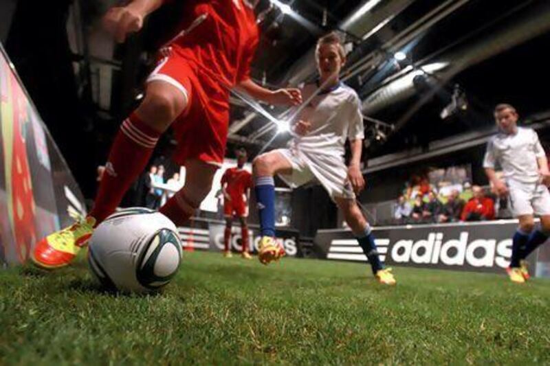 Young footballers play a demonstration match with the new adizero boots during the F50 miCoach launch event in Zurich, Switzerland. Alexander Hassenstein / Getty Images