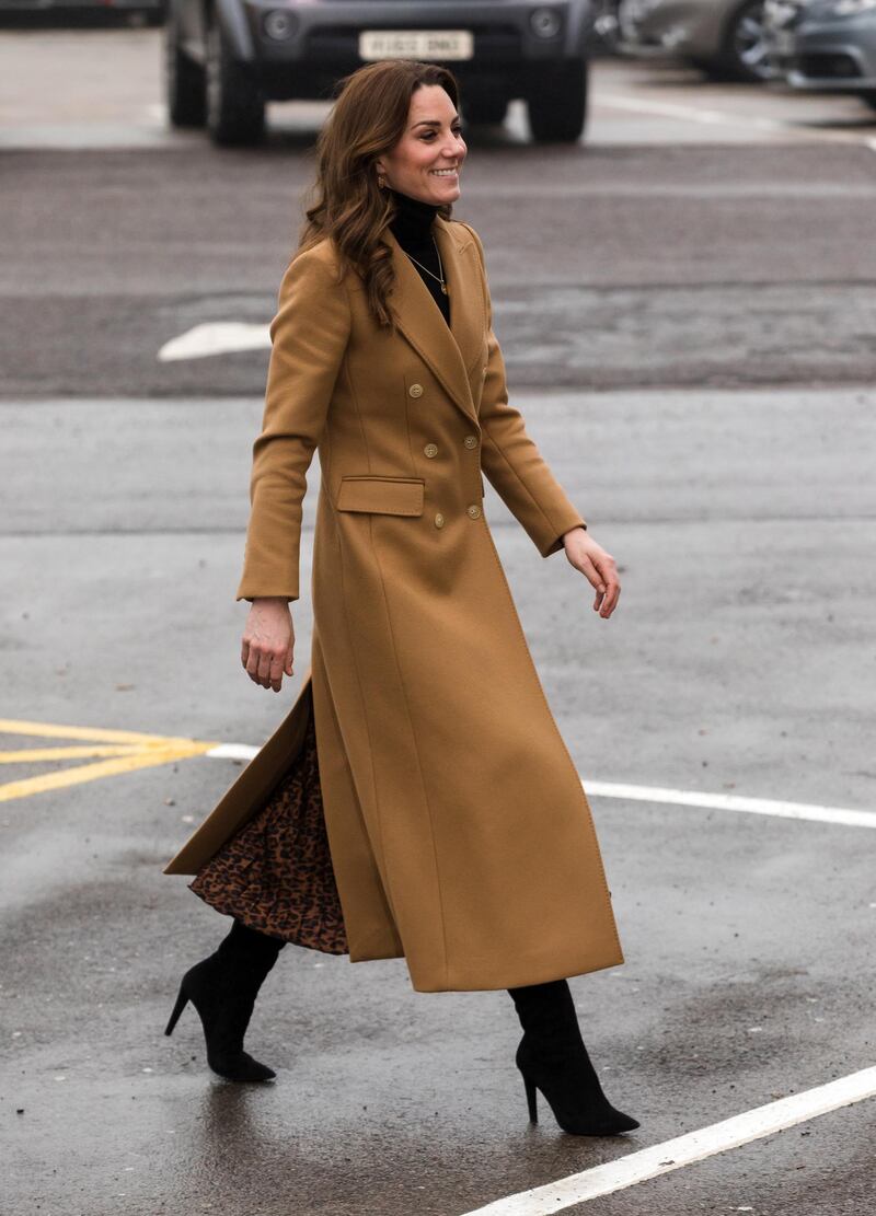 Continuing on her high street fashion spree, the Duchess of Cambridge wears a camel coat by Massimo Dutti, leopard print skirt by Zara and a black turtle neck jumper to arrive at the HMP Send, a resettlement prison for sentenced women in Surrey, Britain, on Wednesday, January 22. EPA