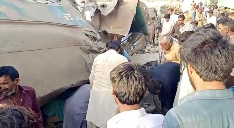 This video grab shows people gathering at the site of a train crash in Ghotki, Pakistan. AP Photo