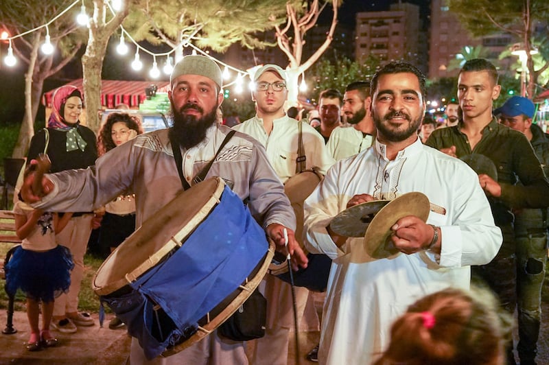 A musaharati drummer passes through the crowds at the Ramadan Village, Tripoli. Photo: Olivia Cuthbert 