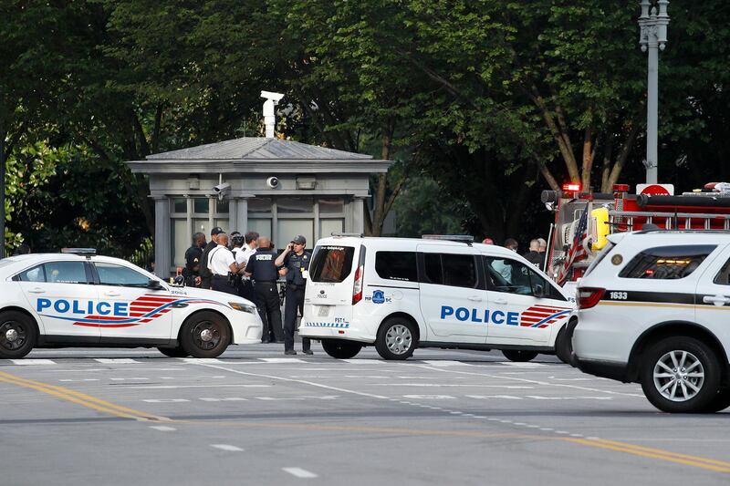 Law enforcement officials gather following a shooting that took place at 17th Street and Pennsylvania Avenue near the White House. AP Photo