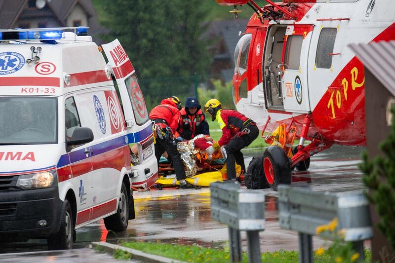 Polish rescue workers move an injured tourist into a helicopter near Zakopane, Poland on August 22, 2019 after a sudden lightning storm killed five people, including two children, in the Polish and Slovakia Tatra mountains, and more than 20 others were injured. 
  / AFP / Piotr KORCZAK
