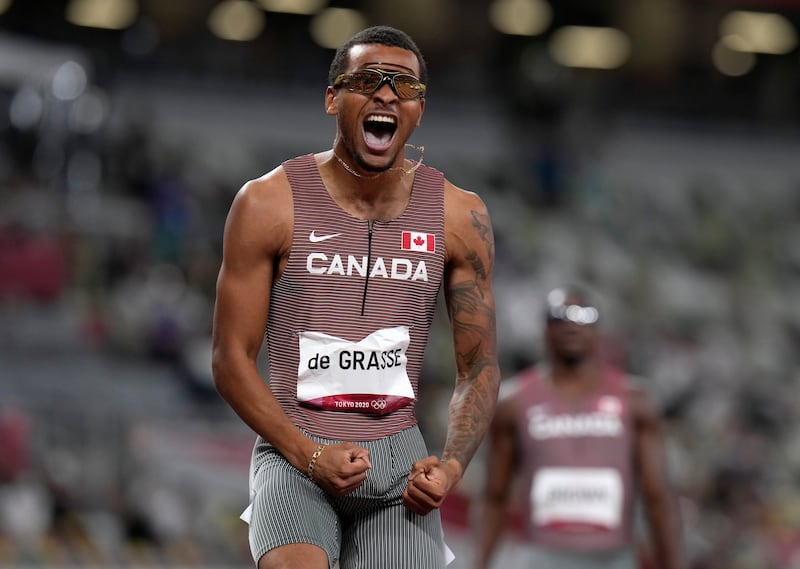 Andre De Grasse celebrates after winning gold in the 200m at the 2020 Tokyo Olympic Games.