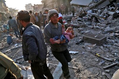 A Syrian man carries a child following a reported airstrike on the rebel-held town of Atareb in Syria's northern Aleppo province on November 13, 2017.
At least 21 civilians, including five children, were killed on Monday in air strikes on Syria's northern Aleppo province, despite a "de-escalation zone" in place there, the Britain-based Syrian Observatory for Human Rights said .
 / AFP PHOTO / Zein Al RIFAI