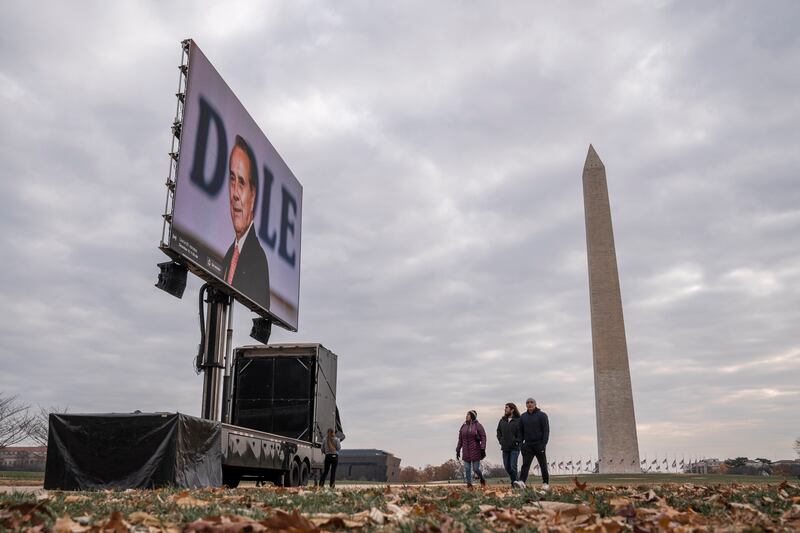 A monitor showing a photo of Bob Dole is seen near the Washington Monument before a tribute ceremony at the World War II Memorial in Washington. EPA