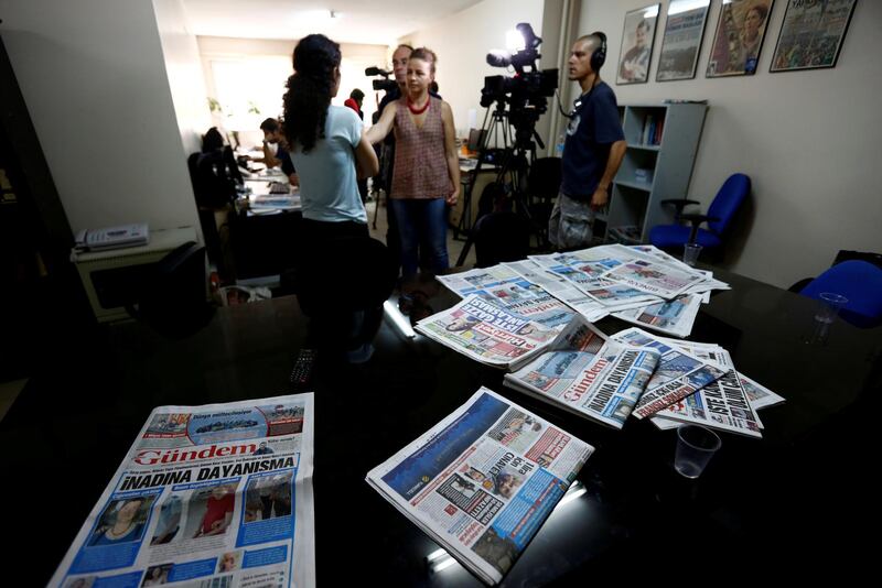 FILE PHOTO: A journalist of pro-Kurdish Ozgur Gundem gives an interview to a German TV channel at their newsroom before a protest against the arrest of three prominent campaigners for press freedom, in front of the pro-Kurdish Ozgur Gundem newspaper in central Istanbul, Turkey, June 21, 2016. REUTERS/Murad Sezer/File Photo