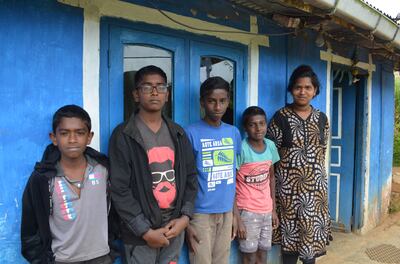 15-year-old Yovan (centre) with other children who have been forced to drop out of school at the tea estate.