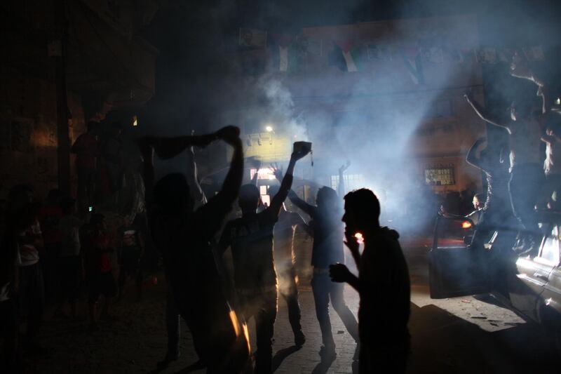 Palestinians react to the news that  Mohammed Assaf is announced the winner of the  regional 'Arab Idol' singing contest held in Beirut , Lebanon June 22,2013 outside Assaf's home in a refugee camp in Khan Younis , Gaza .Thousands of Palestinians in Gaza and the West Bank took to the streets to celebrate his victory. (Photo by Heidi Levine/Sipa Press). *** Local Caption ***  IMG_0603.jpg