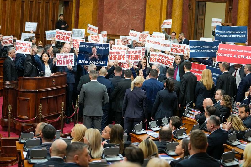 Opposition lawmakers hold banners reading: "Stole the elections" during a Serbia's parliament constitutive session in Belgrade, Serbia.  Serbia's National Assembly held an inaugural session on Tuesday as ruling nationalists ignored widespread reports that parliamentary and municipal elections held in December were marred by vote rigging and other irregularities.  AP