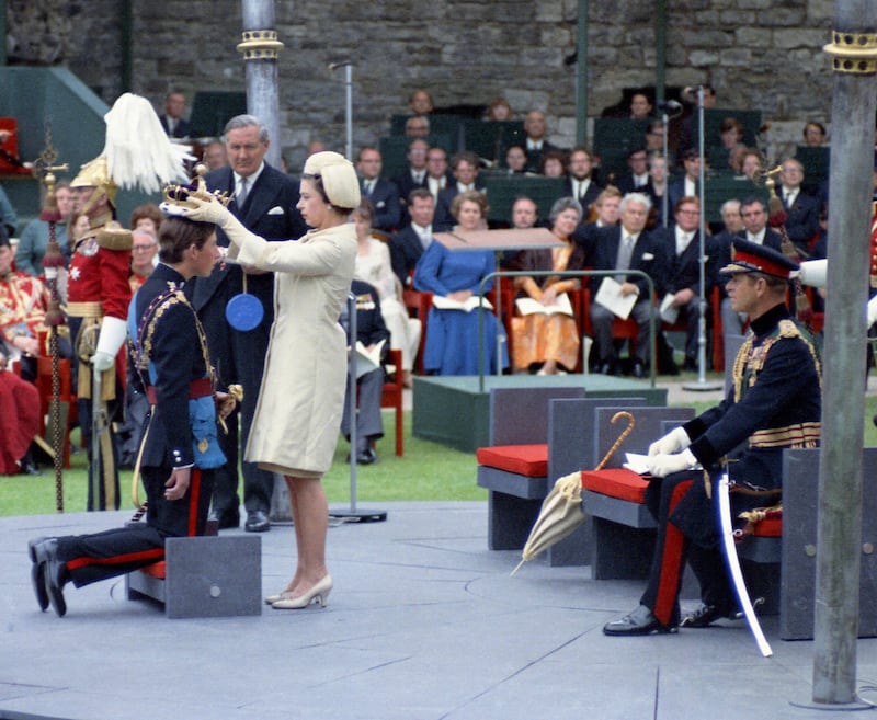 Queen Elizabeth II crowns her son Charles, then Prince of Wales, during his investiture ceremony on July 1, 1969 at Caernafon Castle in Wales. Prince Philip the Duke of Edinburgh is seated at right. AP
