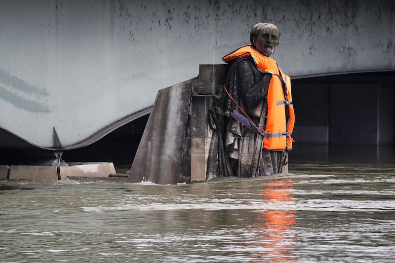 The Zouave statue of the Pont D'Alma bridge standing partially submerged after the River Seine burst its banks in Paris, wears a life jacket put by activists of the Foundation Goodplanet. Francois Guillot / AFP Photo
