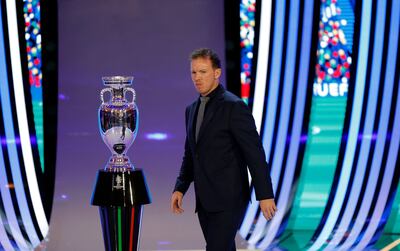 Germany's head coach Julian Nagelsmann is seen next to the trophy after the final draw for the UEFA Euro 2024 European Championship. AFP