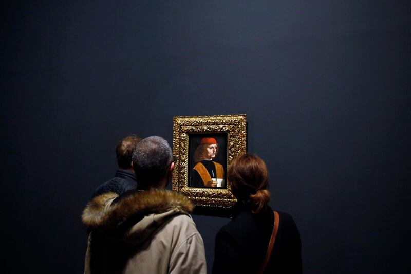 Journalists watch the painting "Portrait of a Musician" by Leonardo Da Vinci, at the Louvre museum, in Paris.  AP