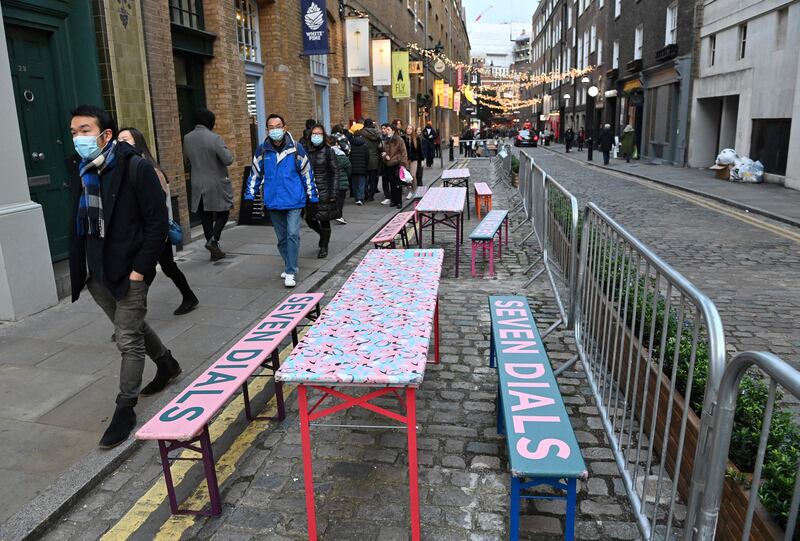 Empty tables outside a restaurant in the Seven Dials district of London. Covid-19 infections have surged in recent days, authorities say. AFP