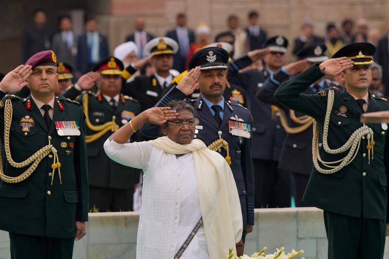 Ms Murmu salutes during tributes to Gandhi in New Delhi. AP