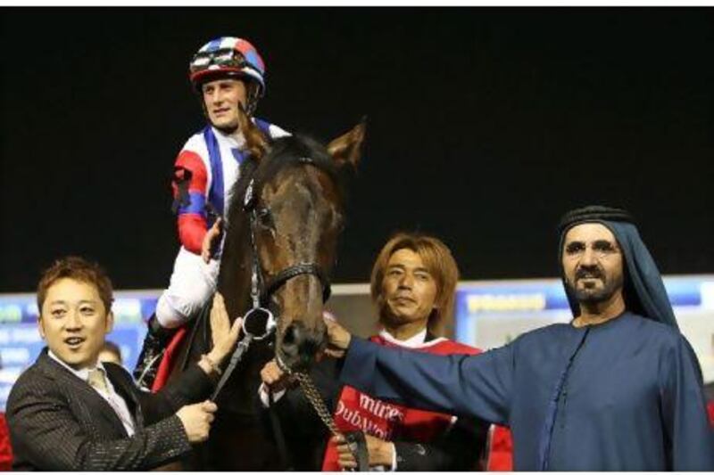 Sheikh Mohammed bin Rashid, right, with the Dubai World Cup-winning horse Victoire Pisa from Japan. Ali Haider / EPA