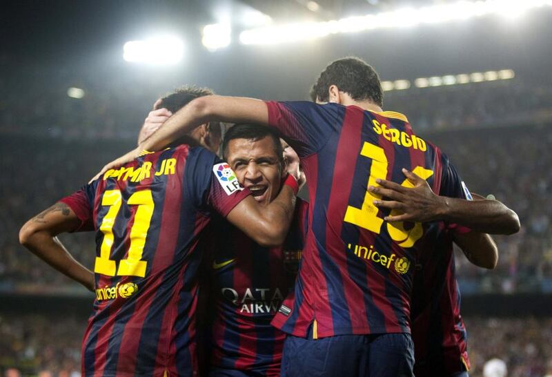 alexis Sanchez, centre, scored Barcelona’s second goal in their 2-1 win over Real Madrid. Alejandro Garcia / EPA

