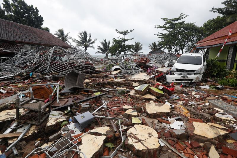 A view of damage with a car sitting among debris in Tanjung Lesung. EPA