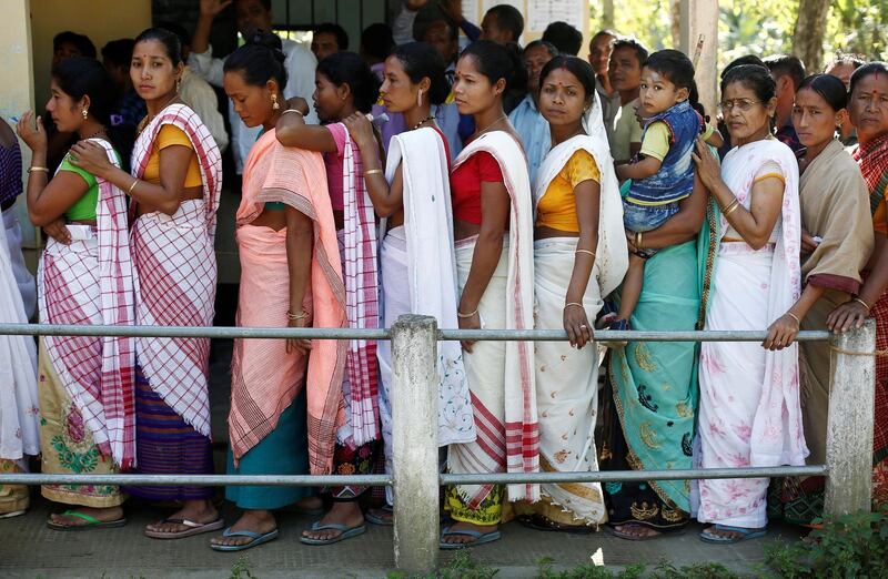 People line up to cast their votes outside a polling station in Majuli, a large river island in the Brahmaputra river, in the northeastern Indian state of Assam. Reuters