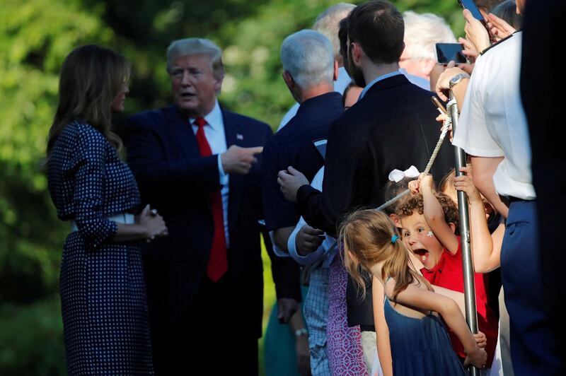 Children react as US President Donald Trump and First Lady Melania Trump interact with guests during the annual Congressional picnic on the South Lawn of the White House in Washington DC. Reuters