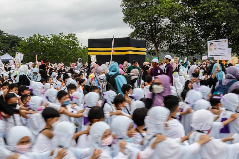 The circumambulation of the replica Kaaba during Little Hajj . in Serdang, outside Kuala Lumpur, Malaysia.