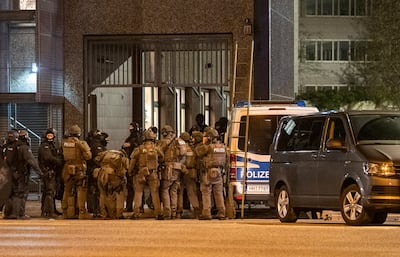 Armed police officers gather near the scene of the shooting in Hamburg. AP