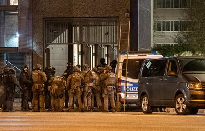 Armed police officers gather near the scene of the shooting in Hamburg. AP