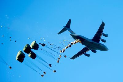 A Charleston AFB C-17 Globemaster III  aircraft air delivers pallets of water and food to Mirebalais, Haiti. US Air Force